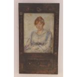 An Arts & Crafts period half-length portrait miniature, a seated girl with flowers in her lap