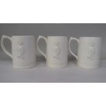 Three identical Keith Murray for Wedgwood cream glazed pottery mugs, bearing moulded head and