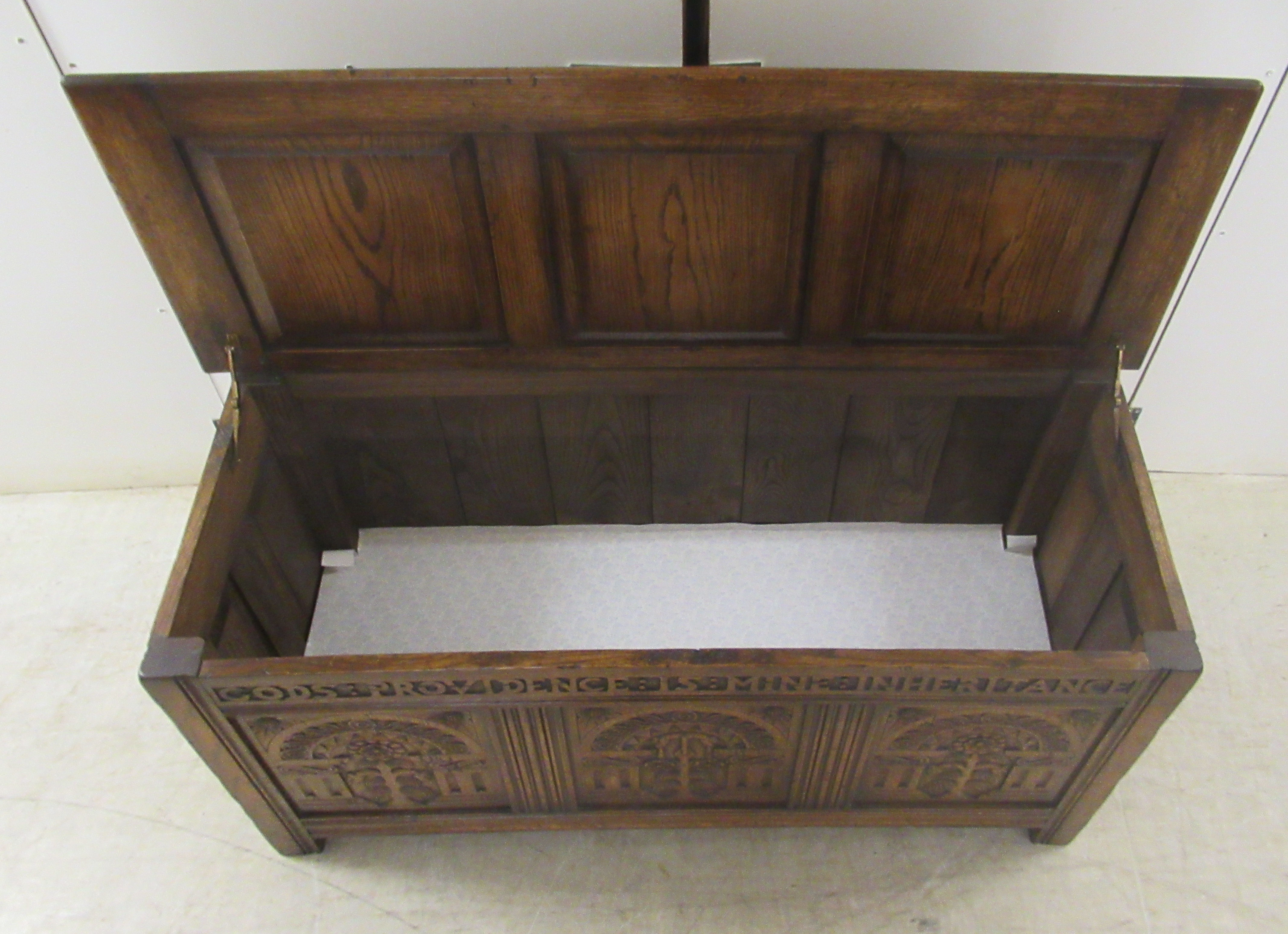 A Brights of Nettlebed period style, tri-panelled oak chest, the front with relief carved - Image 7 of 7