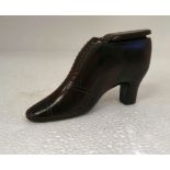 A 19thC treen carved wooden novelty snuff box, fashioned as a studded ankle boot with a sliding lid