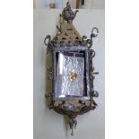 An Arts & Crafts period wrought iron pendant lantern with coloured, leaded glass panels  26"h