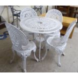A Victorian style white painted patio table  27"h  31.5"dia; and a matching set of four chairs