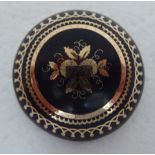 A late 19thC gold coloured metal piquetworked tortoiseshell brooch