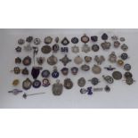 A miscellaneous collection of silver and some part enamelled pin brooches, medallions and
