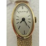 A lady's 9ct gold Bueche Girod, oval cased bracelet wristwatch, faced by a baton dial