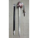A modern Scottish broadsword with a maroon fabric lined basket hilt, the blade 34"L in a steel