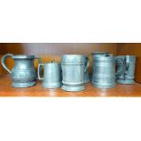 Nine 19thC pewter one pint and half pint tankards, three incorporating glass bottoms