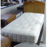 A single mattress and base with a cane bound headboard  36"w