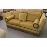 A Duresta two person Knoll settee, upholstered in old gold coloured, tasselled and cushioned