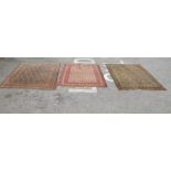 Three similar Persian rugs, on multi-coloured grounds  various sizes