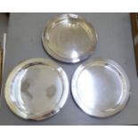 A set of three modern stainless steel trays with raised borders  13"dia