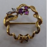 A 9ct gold brooch, set with rubies and diamonds