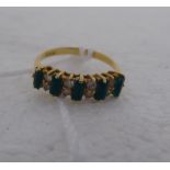 An 18ct gold claw set emerald and diamond ring