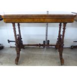 A late Victorian string inlaid and marquetry walnut card table, the octagonal canted edge top