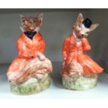 A pair of Staffordshire pottery, seated 'Mr & Mrs Fox' wearing hunting pink  8" & 9"h