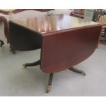 A Regency style mahogany Pembroke dining table, over a vase turned pedestal, raised on a splayed,