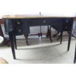 A modern mahogany kidney shape, five drawer kneehole dressing table, raised on square, tapered legs