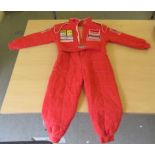 A child's replica red F1 race suit with branded fabric panels  age 5-6 years