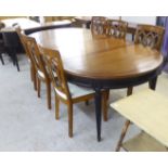 A modern Harrods fruitwood five leg dining table  30"h  61"dia with two additional leaves