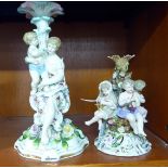 Two similar late 19thC German porcelain centrepiece bases, each surmounted by figures and flora