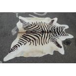 A South American faux cow hide rug  76"L