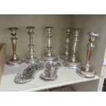 Three pairs of silver plated candlesticks, each with cast ornament  11"h; and two candle snuffers