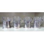 Four Russian moulded glass breakers, in matched white metal frames with loop handles