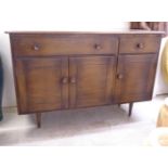 A (probably Ercol) dark stained beech and elm sideboard with two frieze drawers, over three doors,