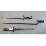 Three late 19th/early 20thC military bayonets, the longest blade 18"L