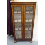 A William IV  rosewood veneered display cabinet, the paper lined and shelved interior enclosed by