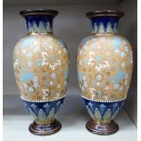 A pair of Royal Doulton stoneware, ovoid shape vases, decorated with floral and foliate designs