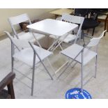 A modern white painted cast metal folding table  29"h  23"w; and a set of four Ghost type, plastic