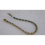 A 14k gold bracelet, set with alternating emeralds and diamonds