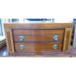 A circa 1910 string inlaid, crossbanded mahogany serpentine front, partially fitted, three drawer