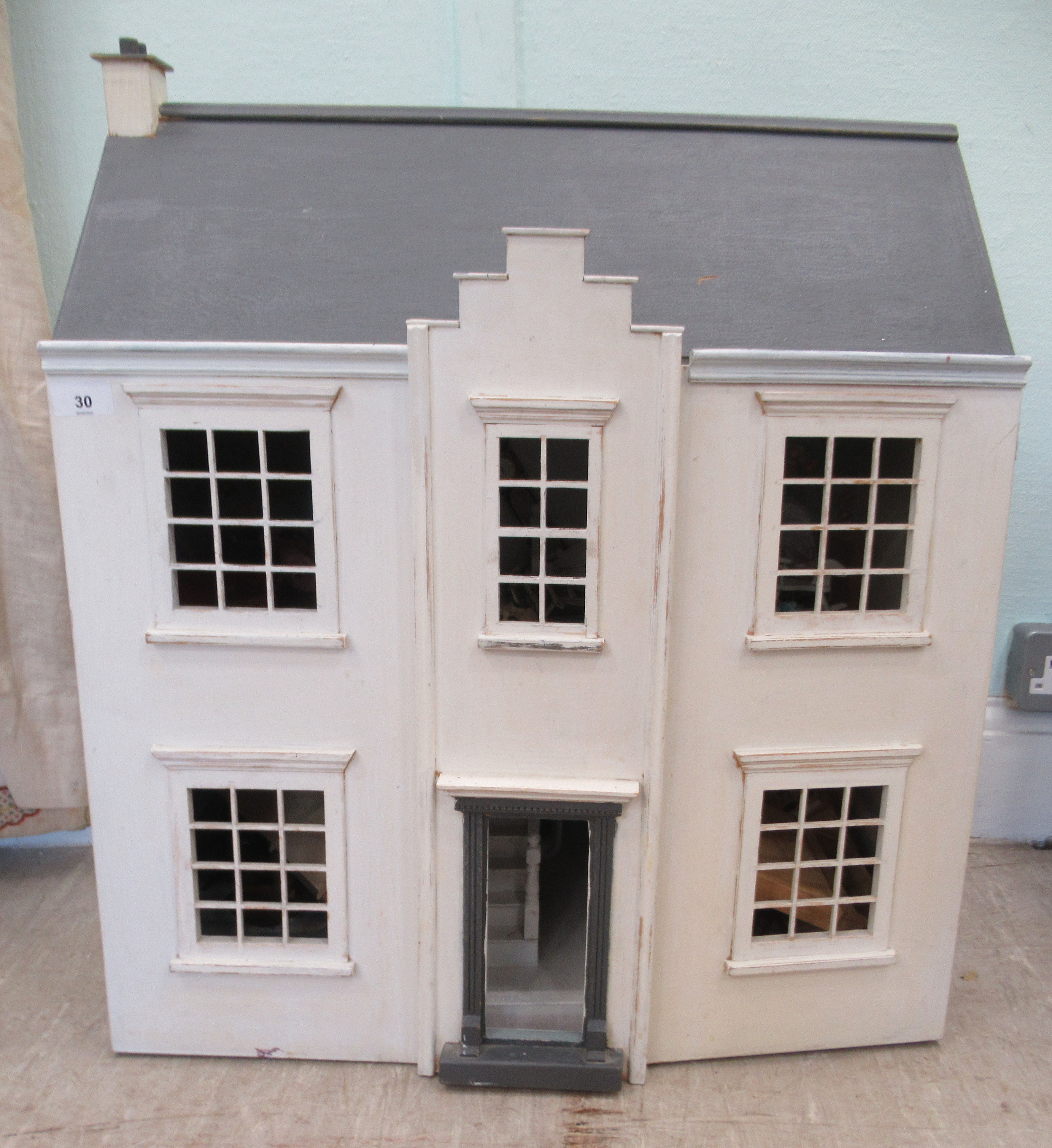 A mid 20thC white and grey painted dolls house  27"h  24"w with a small amount of dolls furniture