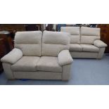 A pair of modern two person settees, upholstered in textured effect biscuit coloured fabric  60"w