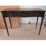 An early 20thC mahogany veneered serpentine front single drawer side table, raised on square,