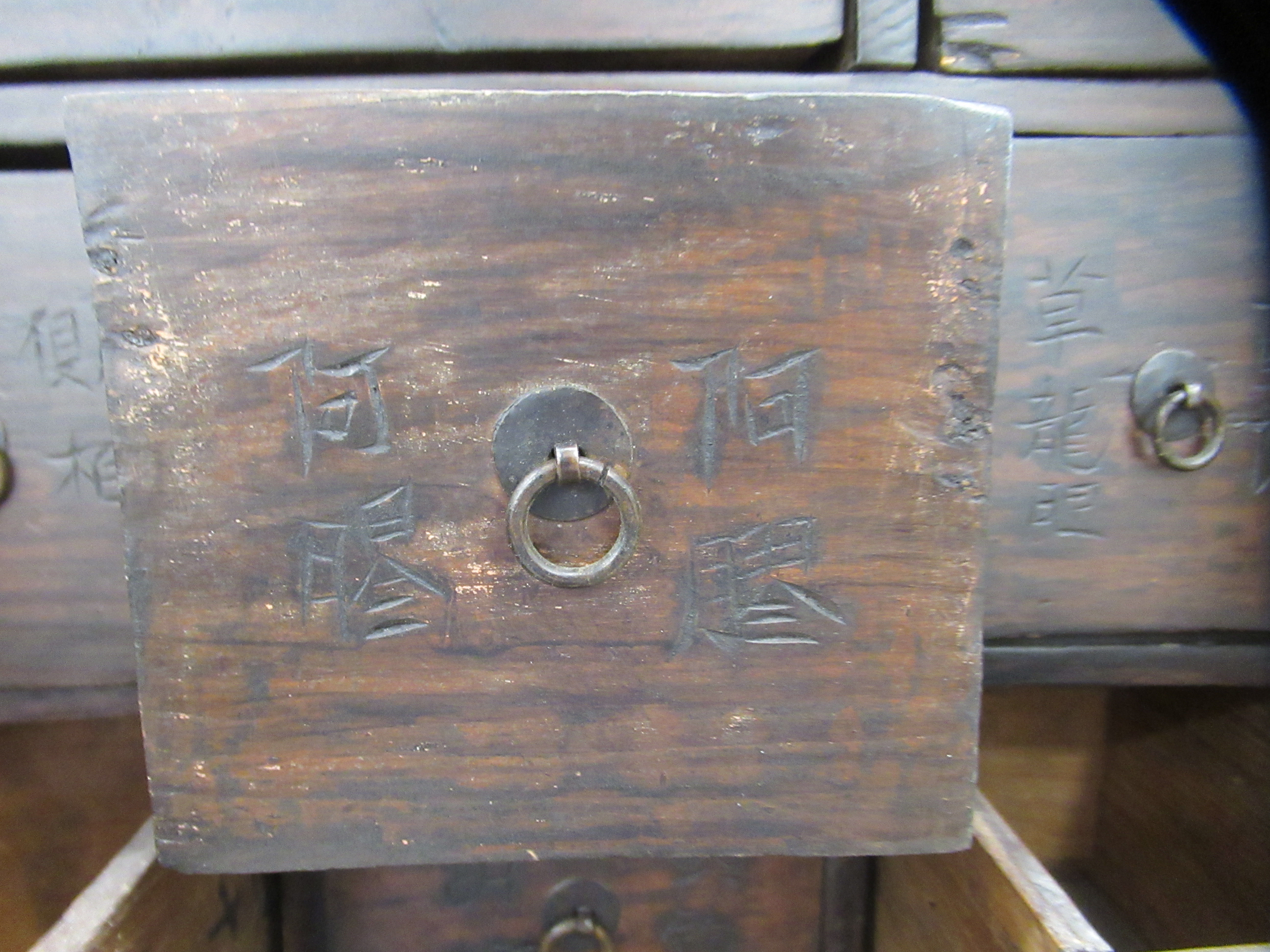 A 20thC Chinese stained pine medicine cabinet with an arrangement of fifty-two drawers, over a - Image 6 of 10