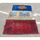 Three small rugs: to include an Iranian example, decorated with flora, on a blue ground  24" x 49"