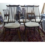 A set of five Ercol dark stained beech and elm framed comb and spindle back dining chairs,