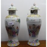 A pair of late 19thC Chinese porcelain vases with covers, each decorated with figures in landscape