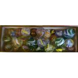 A collection of mostly handblown glass marbles