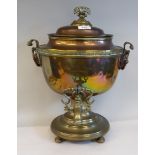 An early 19thC copper samovar with opposing lion mask handles, on ball feet  18"h