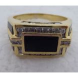 A 14k gold signet ring, set with onyx tablets, surrounded by diamonds