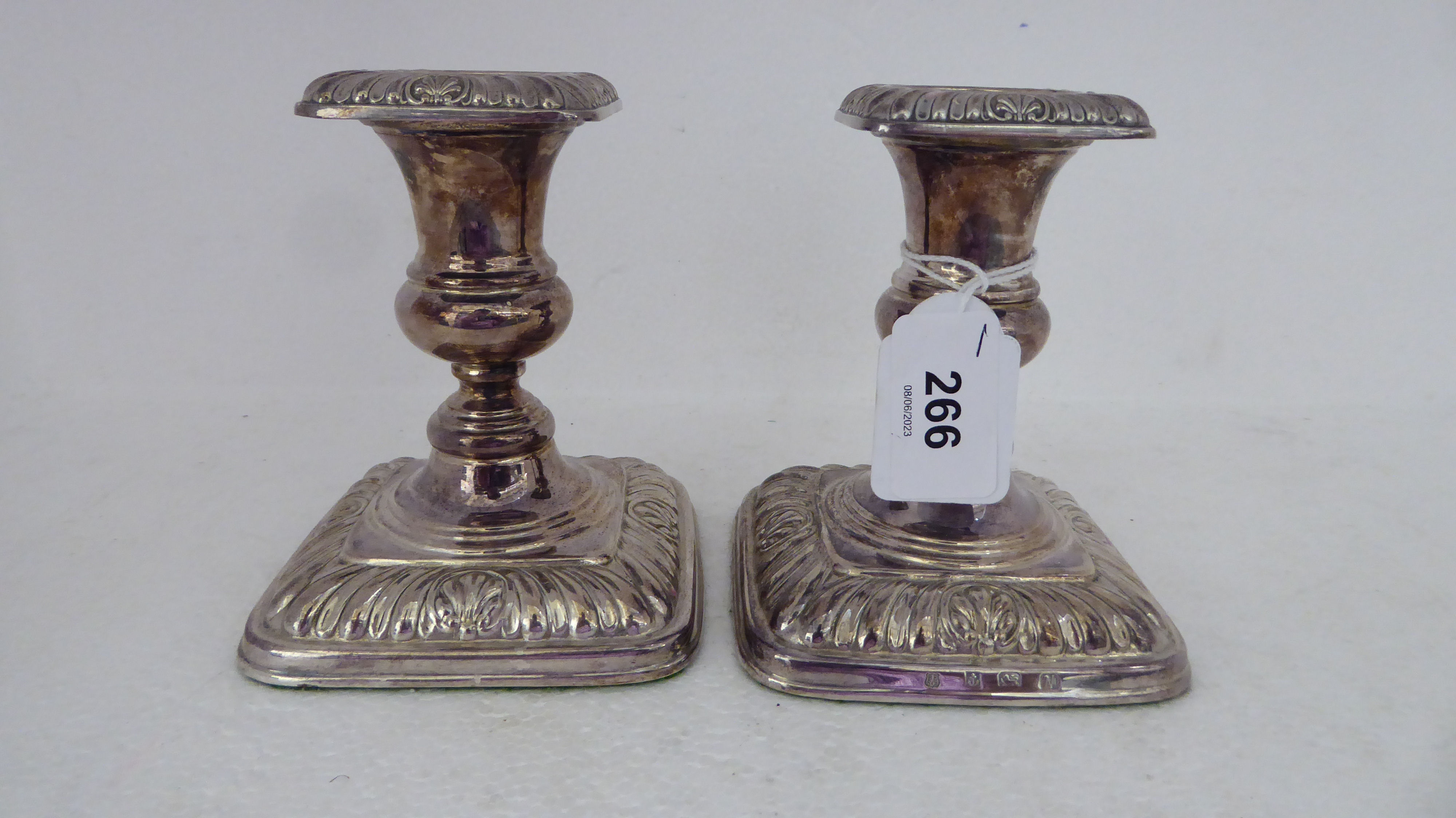 A pair of loaded silver candlesticks with embossed decoration  Birmingham 1987  4.5"h - Image 2 of 6