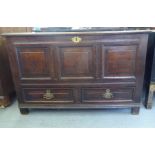 An early/mid 18thC oak mule chest with straight sides, a hinged lid tri-panelled front, over two