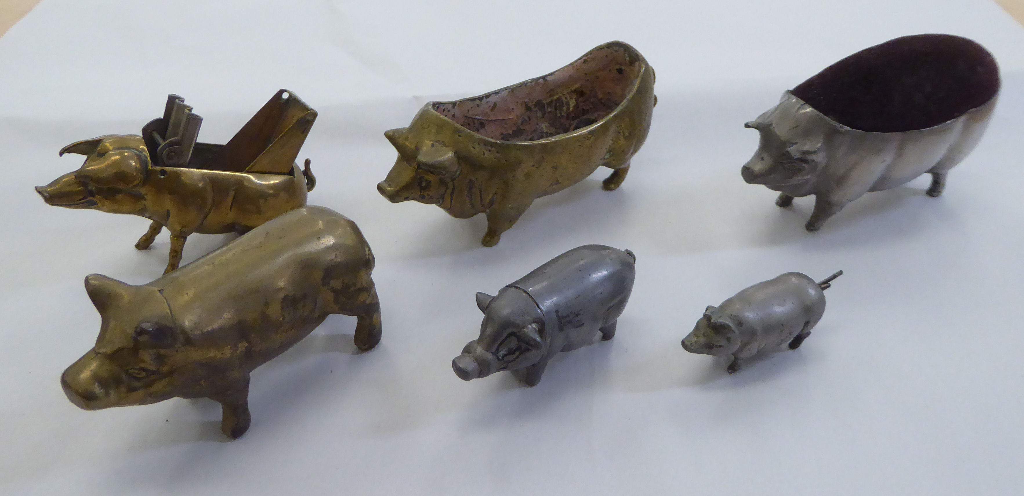 Six 20thC novelty pig themed items, viz. a measure, a vesta, a matchbox sleeve and others