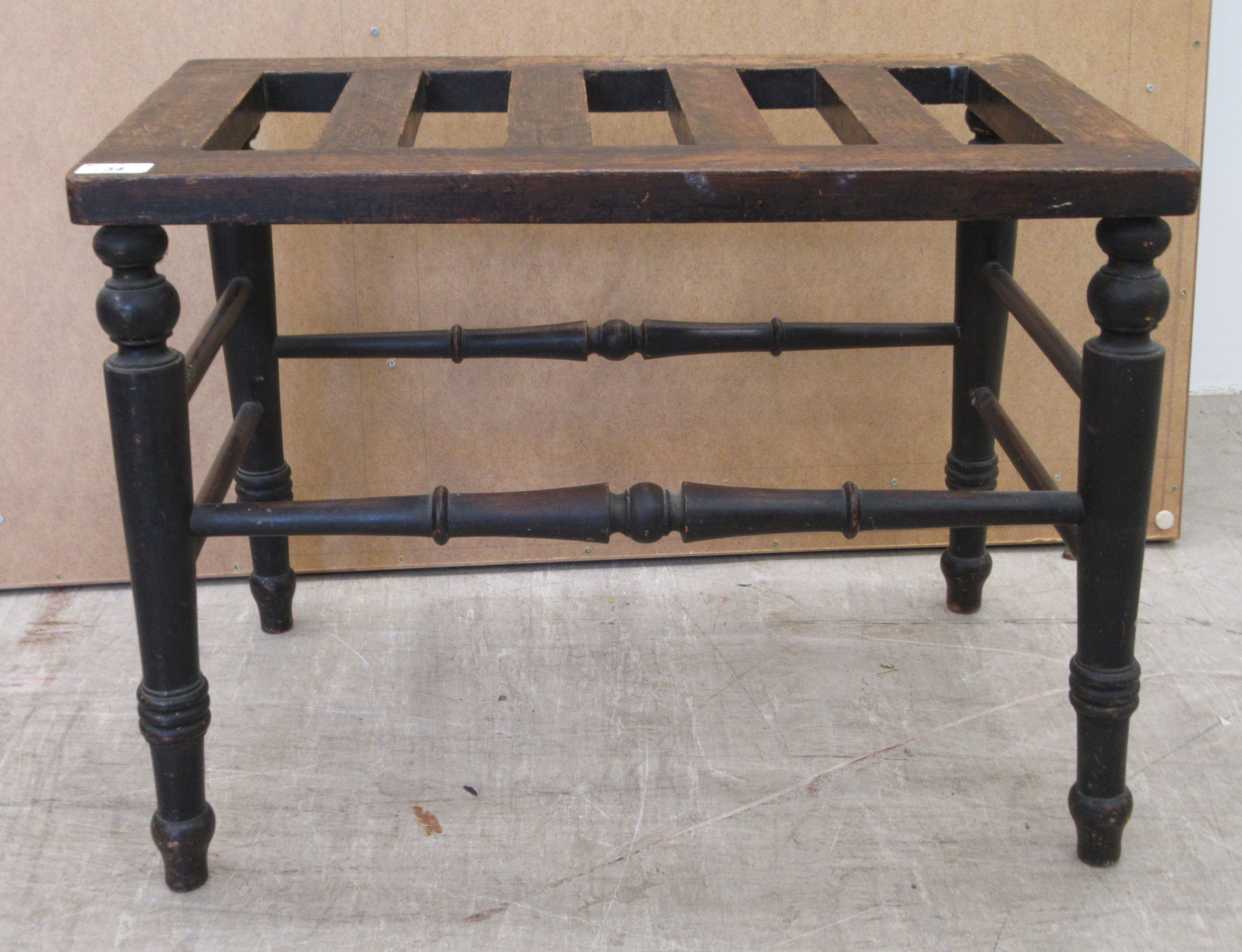 A late Victorian oak luggage stand, raised on turned legs, united by spindle stretchers  18"h  24"w