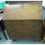 A George III oak bureau with a fall flap, over four graduated drawers, on a plinth and associated