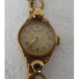 A lady's Rotary 9ct gold cased wristwatch, faced by an Arabic dial, on a 9ct gold expandable strap